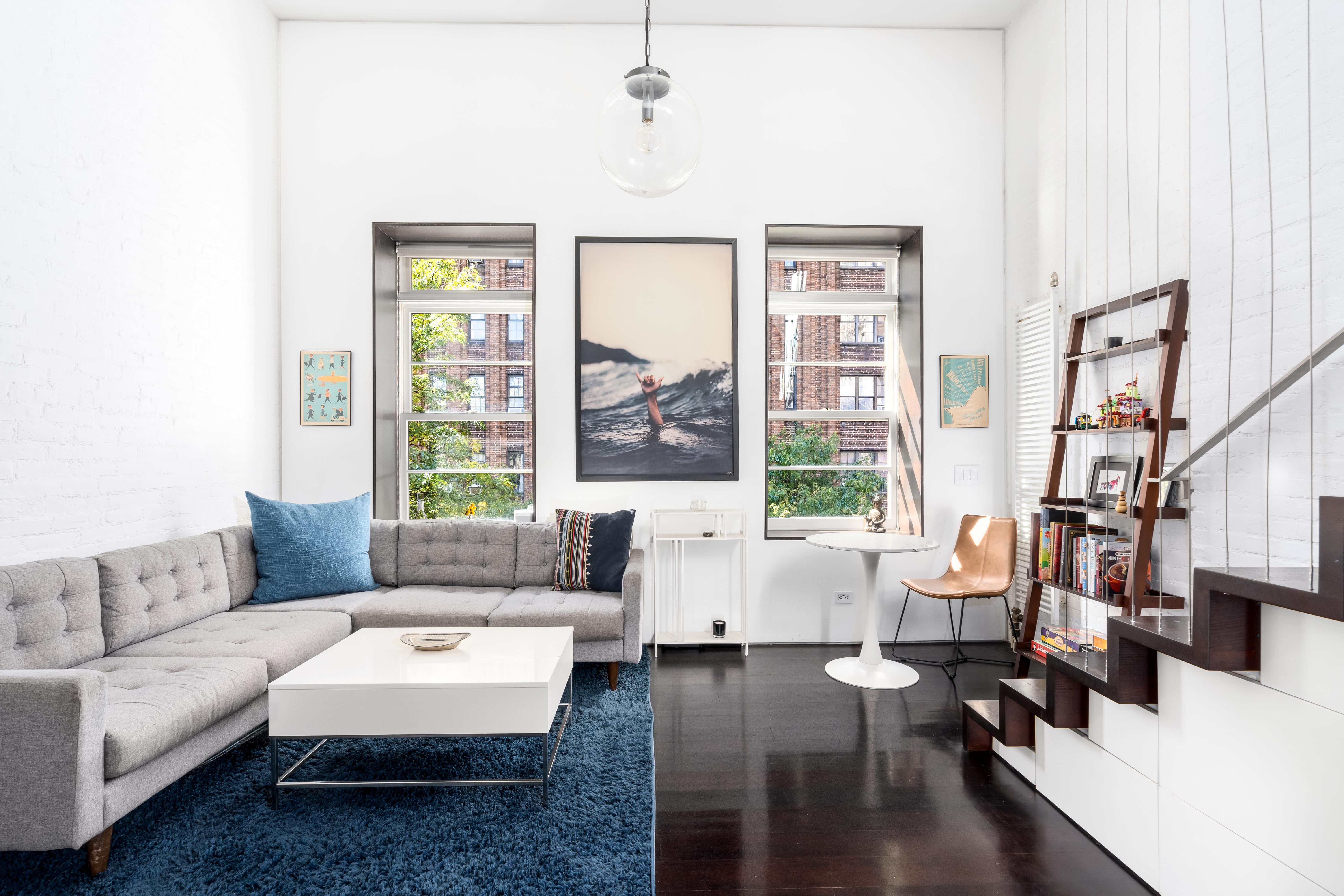 167 West 73rd Street, Unit 9 Manhattan, NY 10023 - Photo 5 of 9 a living room with furniture and a large window