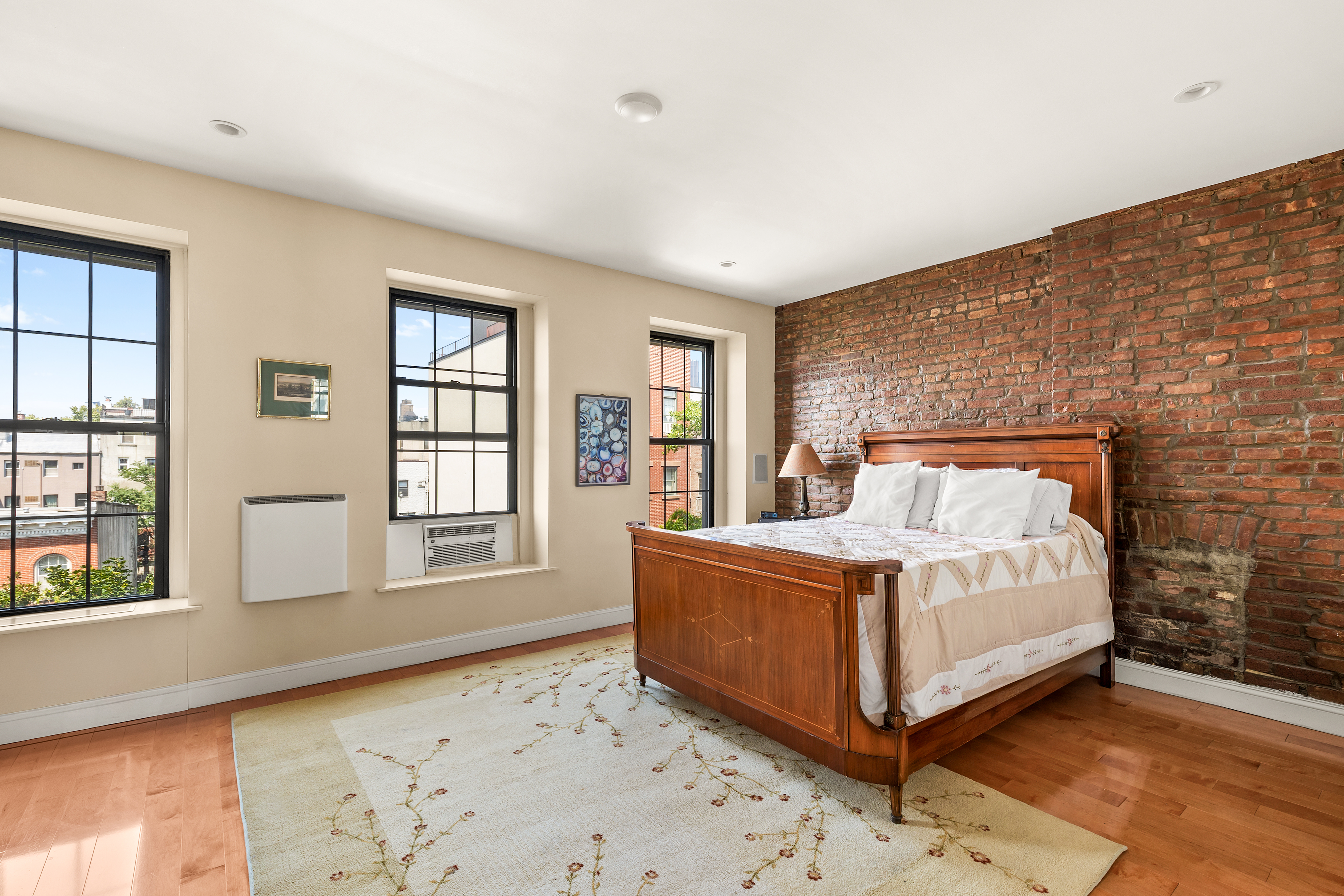 124 Carroll Street, Unit 2 Brooklyn, NY 11231 - Photo 4 of 13 a large bed sitting in a bedroom next to a window