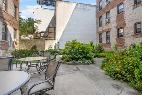 a view of a patio with table and chairs and potted plants