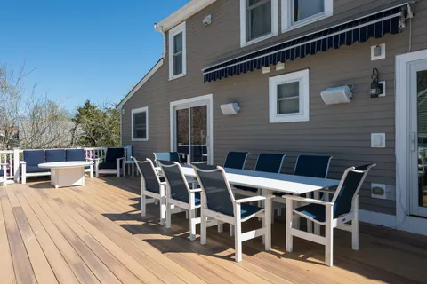 a view of a patio with table and chairs