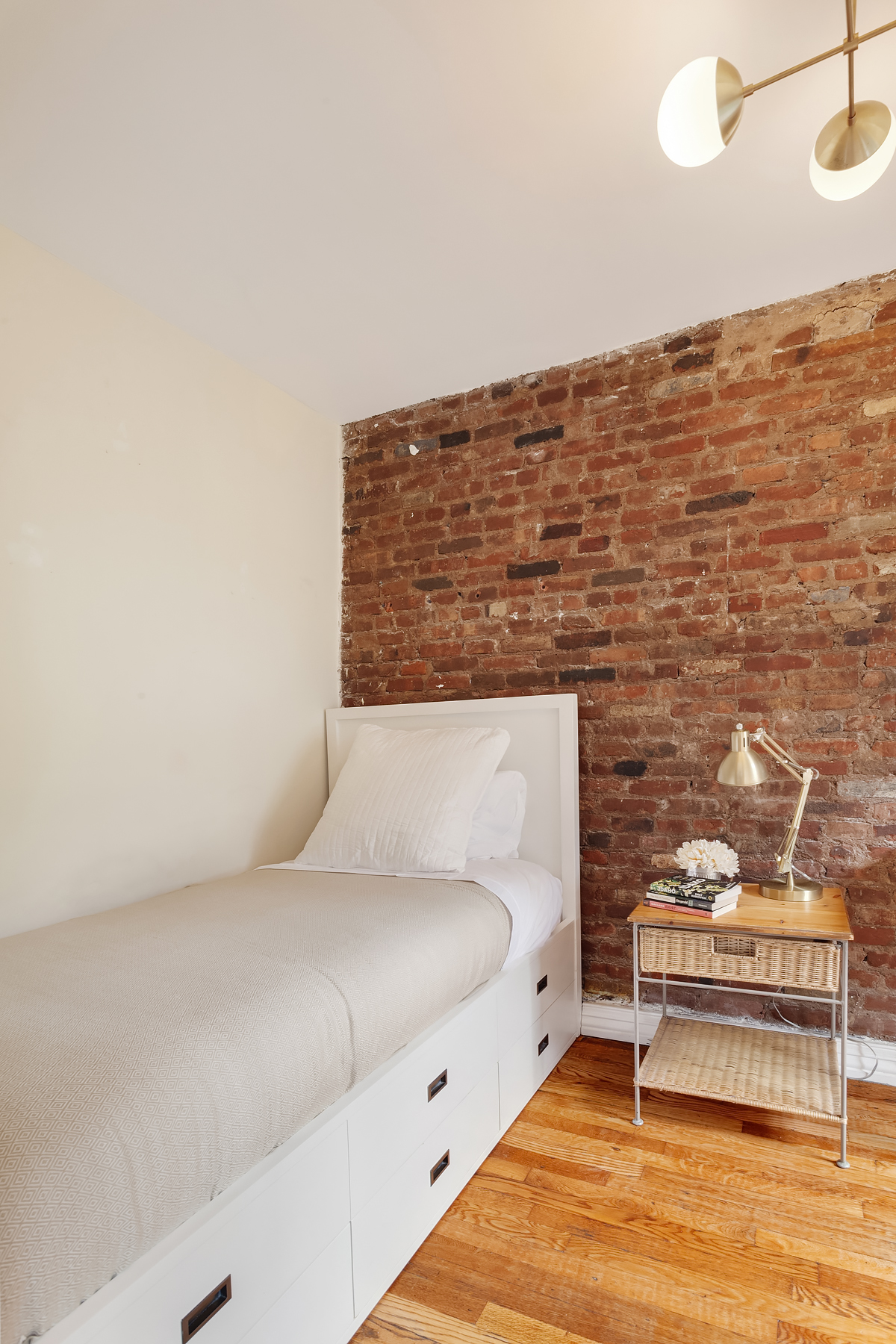 181 Thompson Street, Unit 19 Manhattan, NY 10012 - Photo 3 of 7 a spacious bedroom with a bed and a ceiling fan