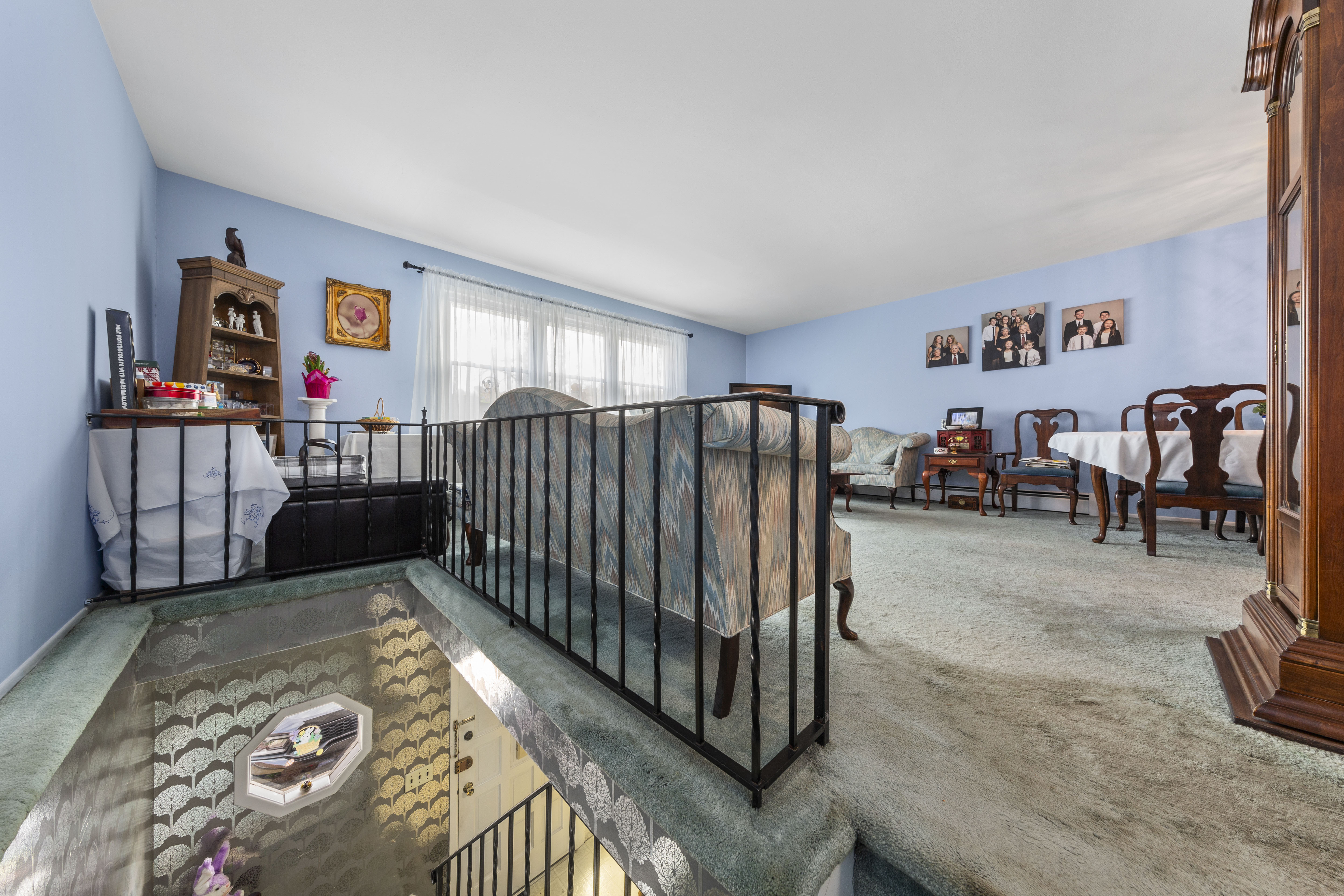 240-47 68th Avenue Queens, NY 11362 - Photo 14 of 39 a living room with furniture and a baby crib