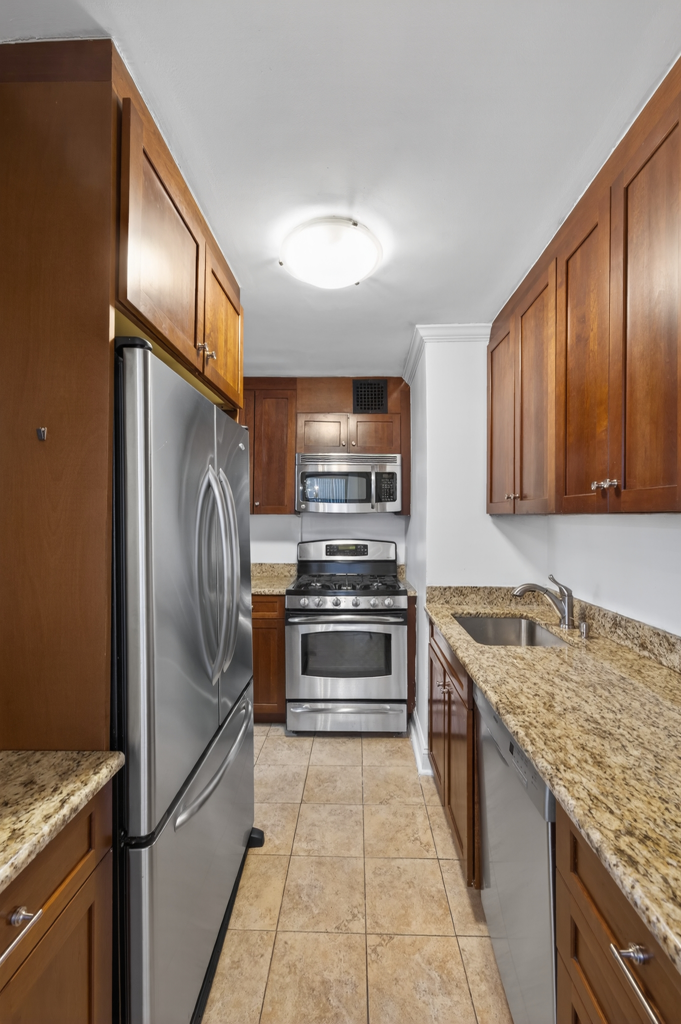 330 3rd Avenue, Unit 8A Manhattan, NY 10010 - Photo 7 of 13 a kitchen with stainless steel appliances granite countertop a refrigerator stove and oven