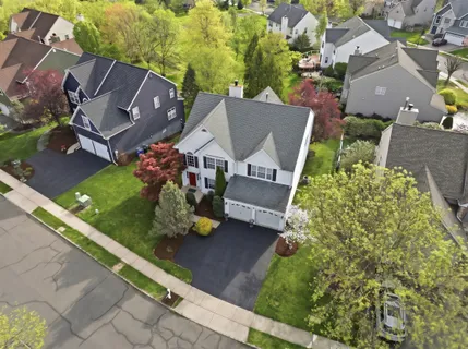 an aerial view of a house with garden space and street view