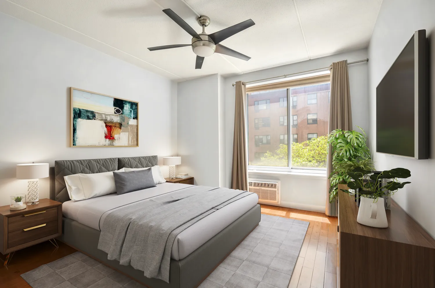 a bedroom with a large bed and a potted plant