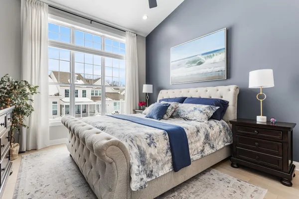 a bed sitting in a bedroom next to a window