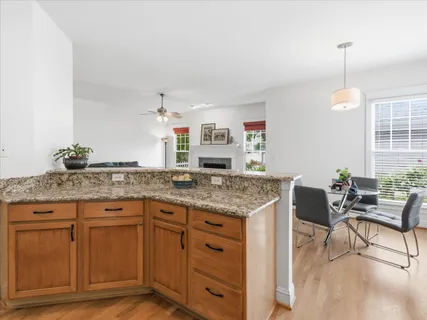 a kitchen with stainless steel appliances granite countertop a refrigerator stove and microwave