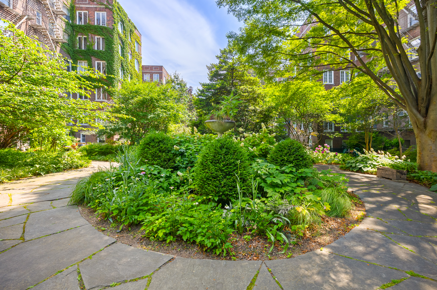 35-27 76th Street, Unit 21 Queens, NY 11372 - Photo 22 of 24 a yellow building with trees in front of it