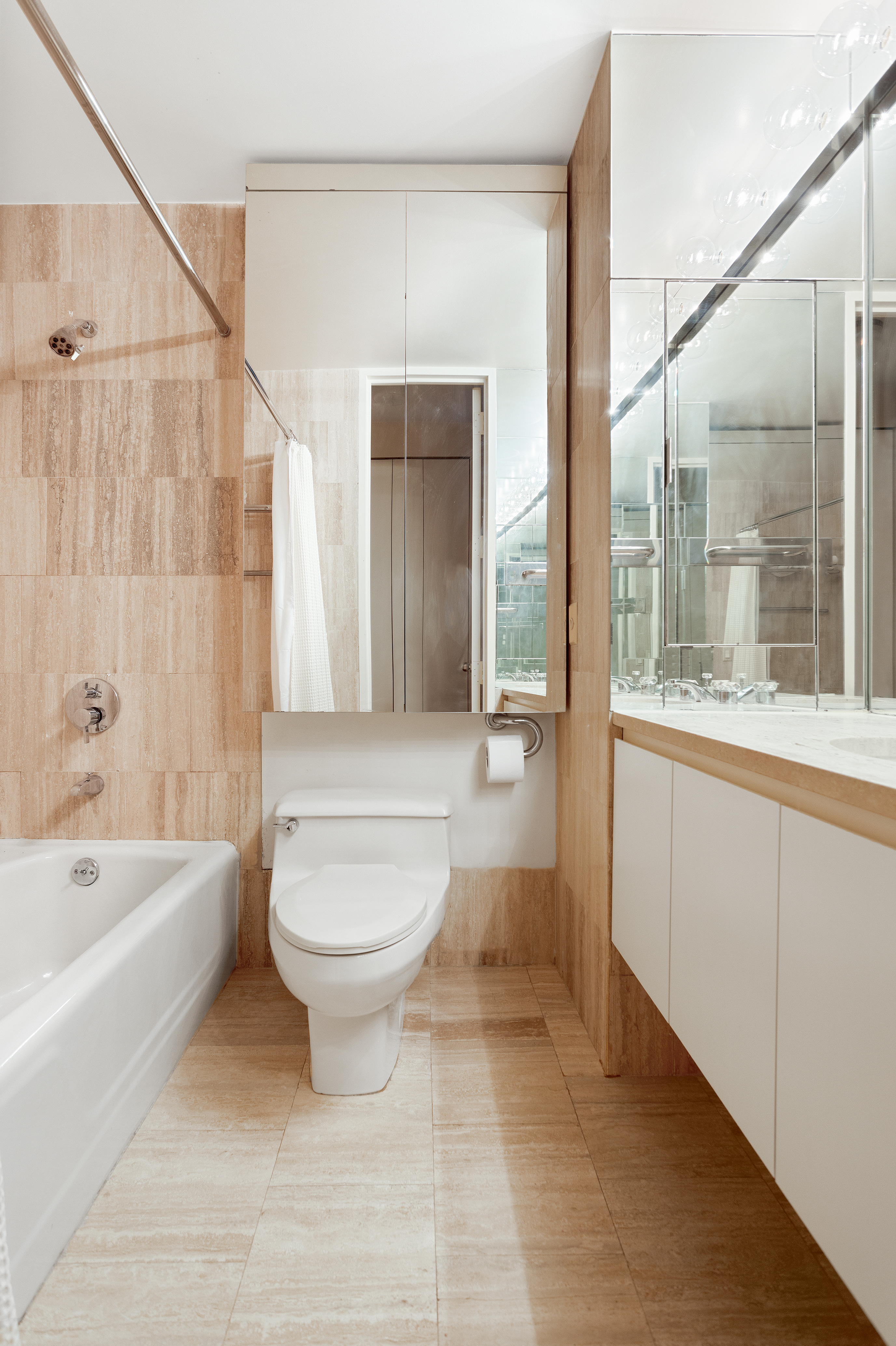 15 West 53rd Street, Unit 11H Manhattan, NY 10019 - Photo 8 of 11 a bathroom with a sink a toilet and shower