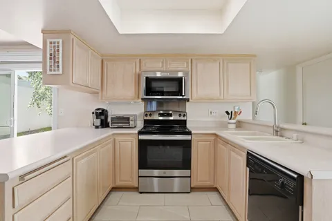 a kitchen with a sink stove and cabinets