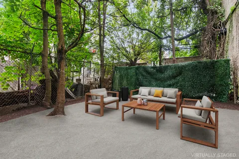 a backyard of a house with outdoor seating