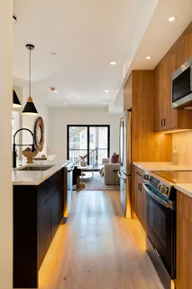 a kitchen with sink stove and refrigerator