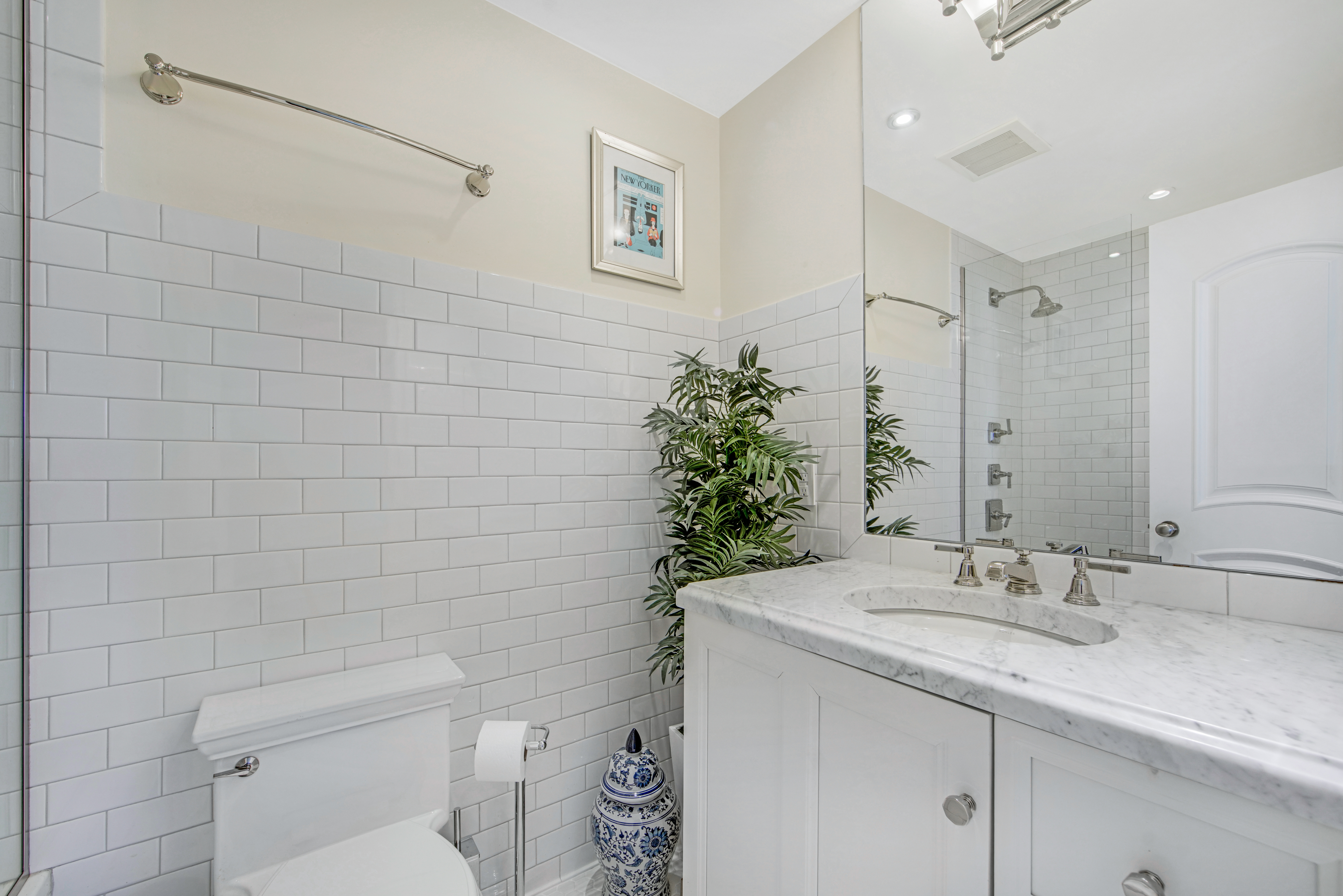 400 East 70th Street, Unit 3301 Manhattan, NY 10021 - Photo 12 of 20 a bathroom with a granite countertop sink a toilet and a mirror