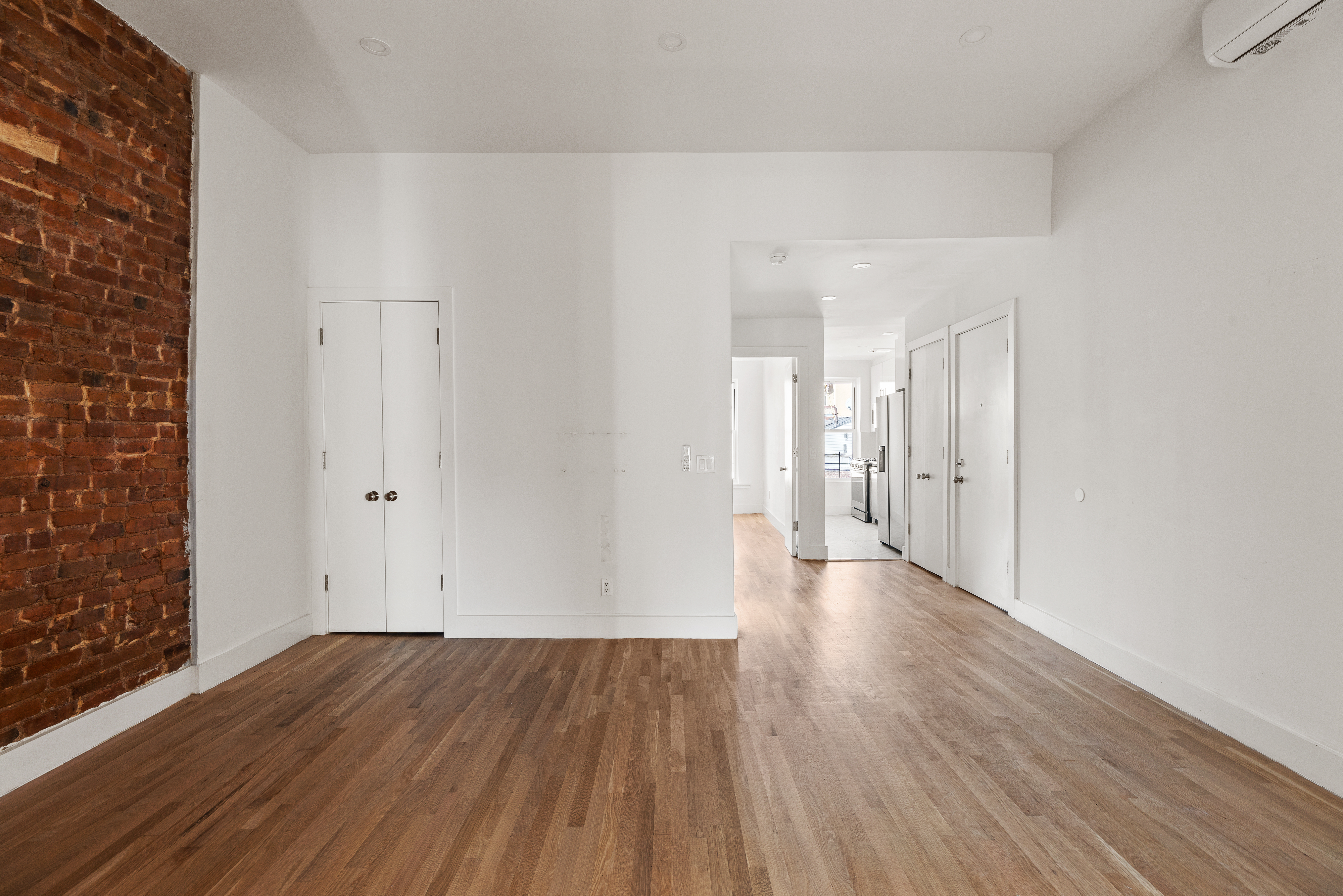 502 5th Avenue, Unit 3 Brooklyn, NY 11215 - Photo 4 of 10 a view of an empty room with wooden floor and a window