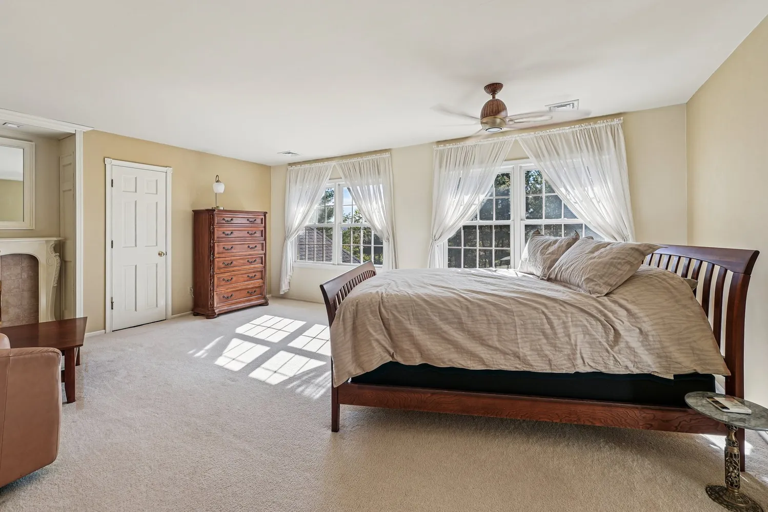 a spacious bedroom with a bed and a couch