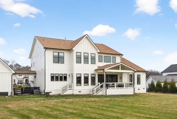 a front view of a house with a yard table and chairs