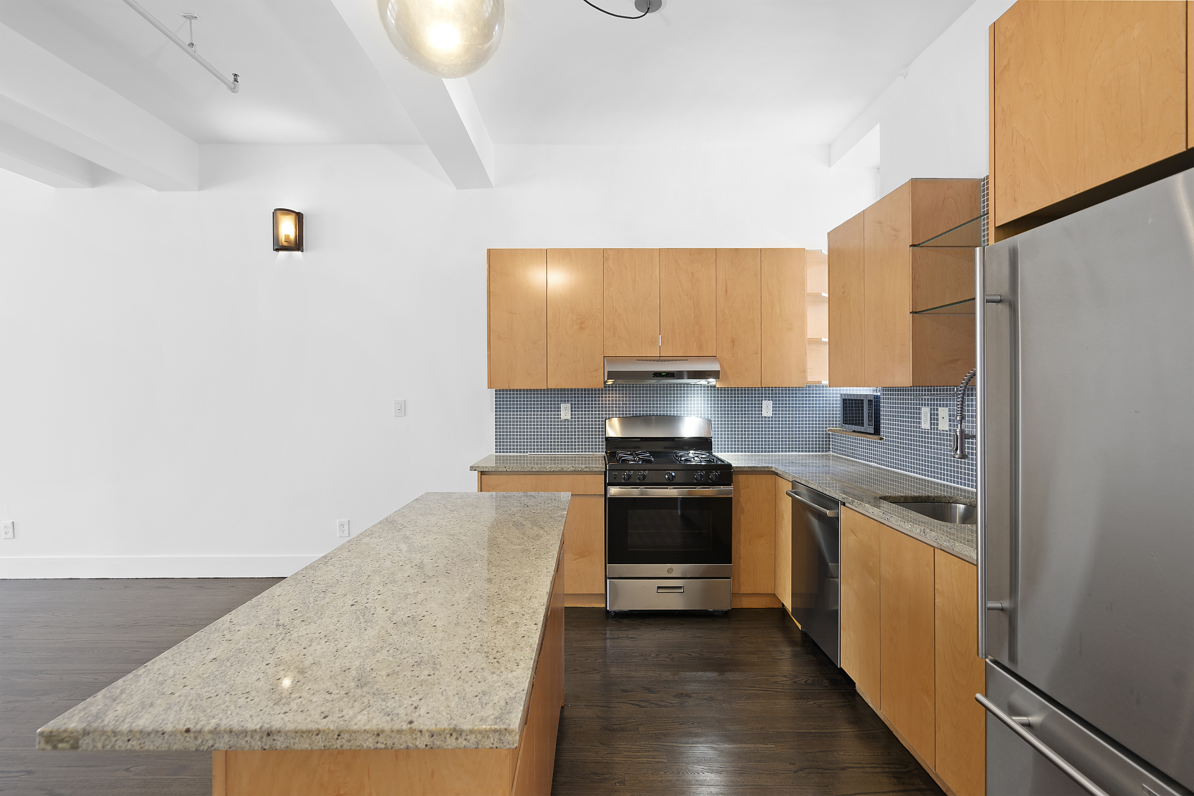 91 Grand Avenue, Unit 2D Brooklyn, NY 11205 - Photo 5 of 16 a kitchen with stainless steel appliances granite countertop a stove a sink and a refrigerator