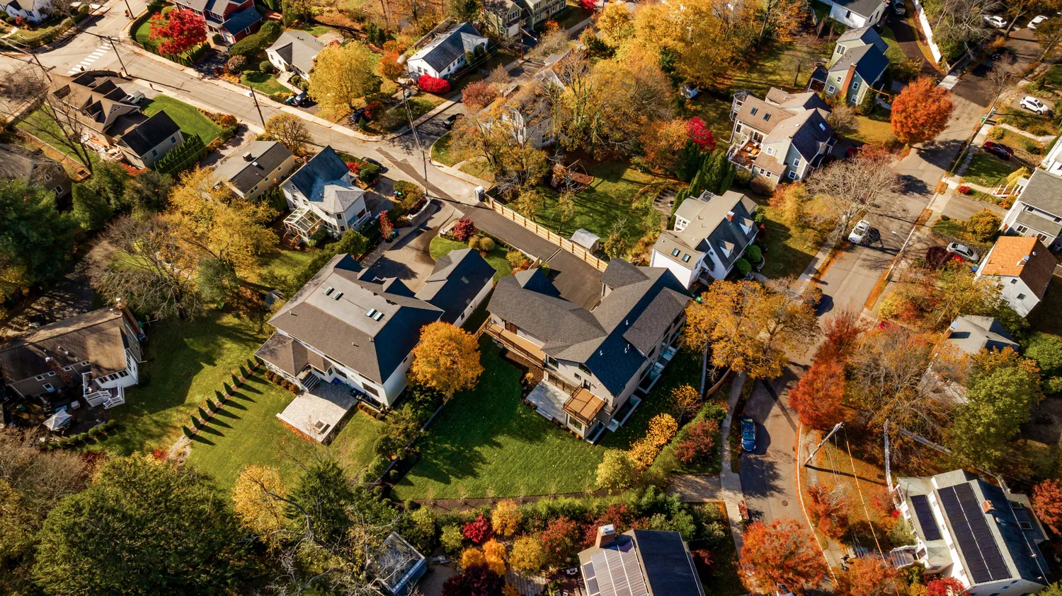 an aerial view of residential houses with outdoor space
