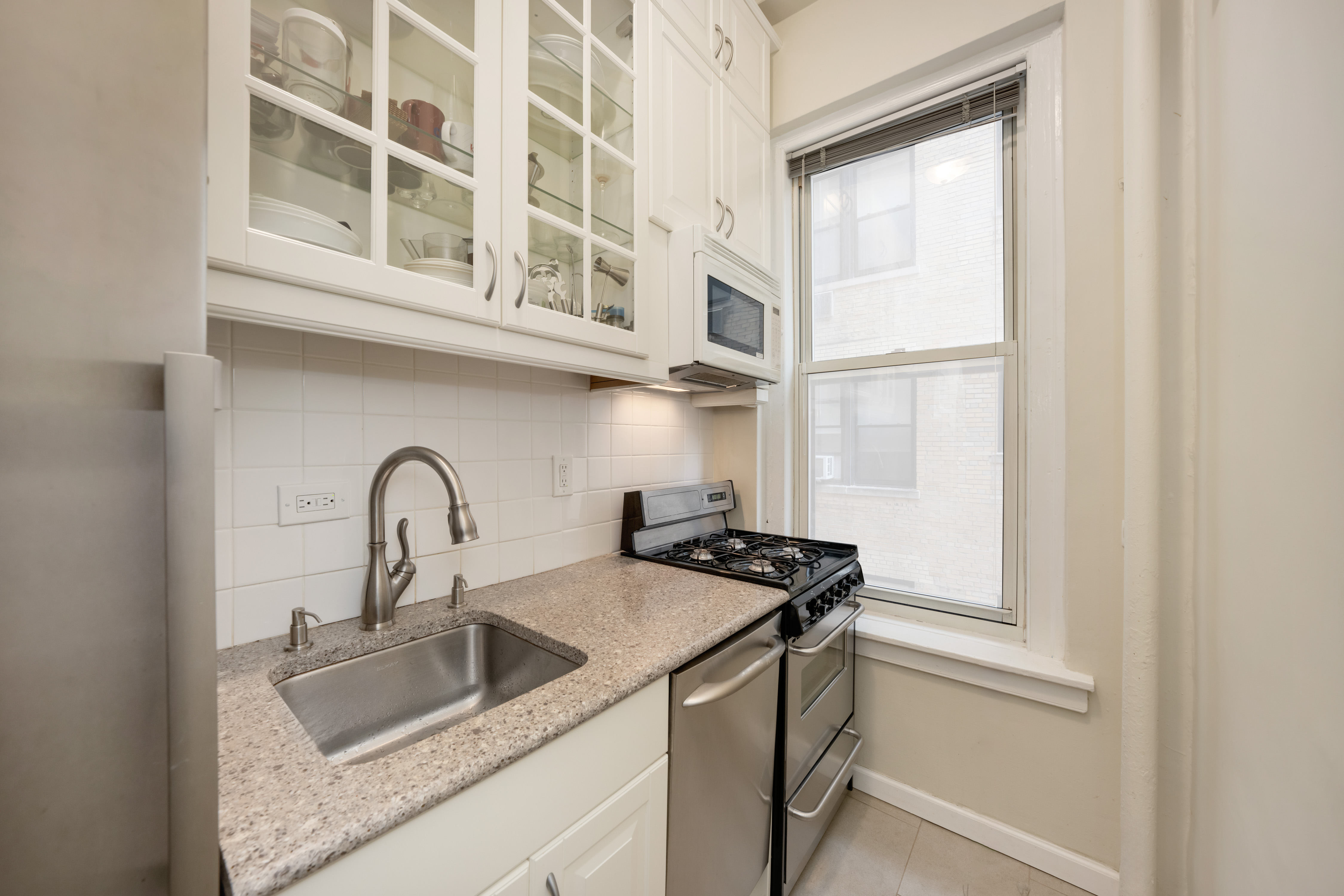 246 West End Avenue, Unit 9F Manhattan, NY 10023 - Photo 3 of 10 a close view of a sink and a window in a kitchen