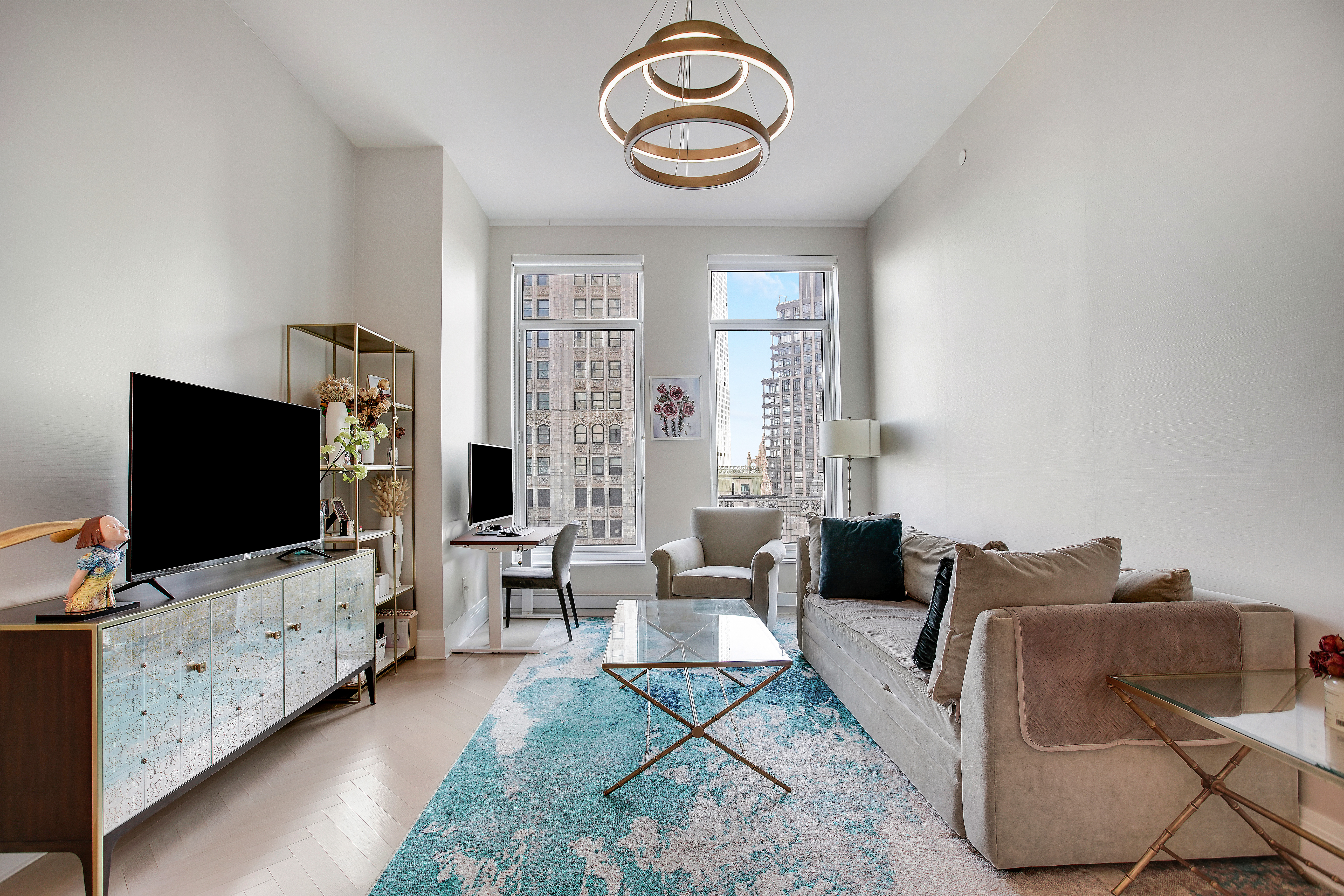 30 Park Place, Unit 46C Manhattan, NY 10007 - Photo 3 of 20 a living room with furniture and a flat screen tv