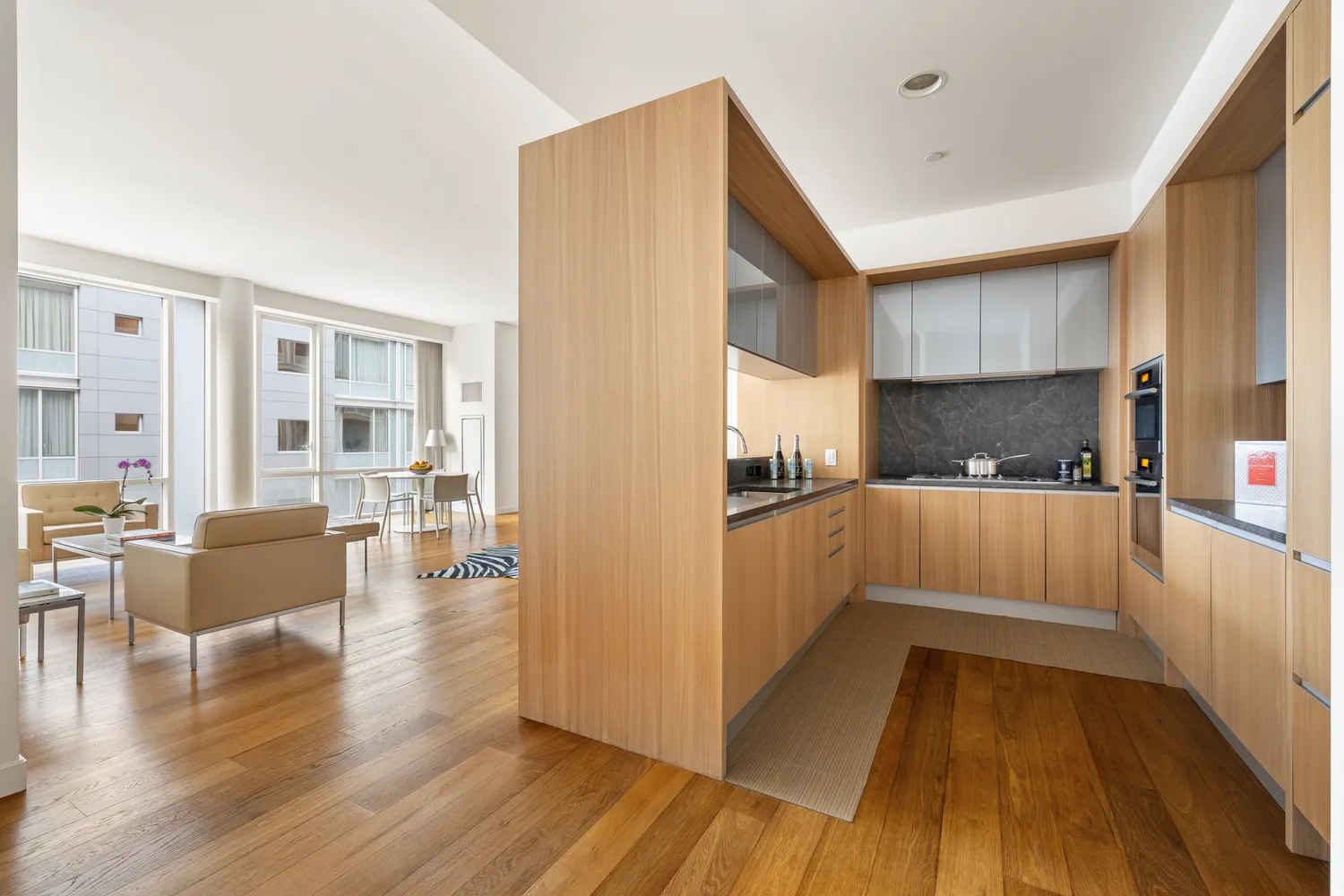 a kitchen with counter top space and wooden floor