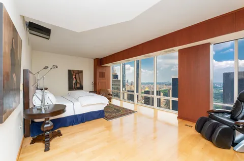 a bathroom with a granite countertop sink a toilet and shower