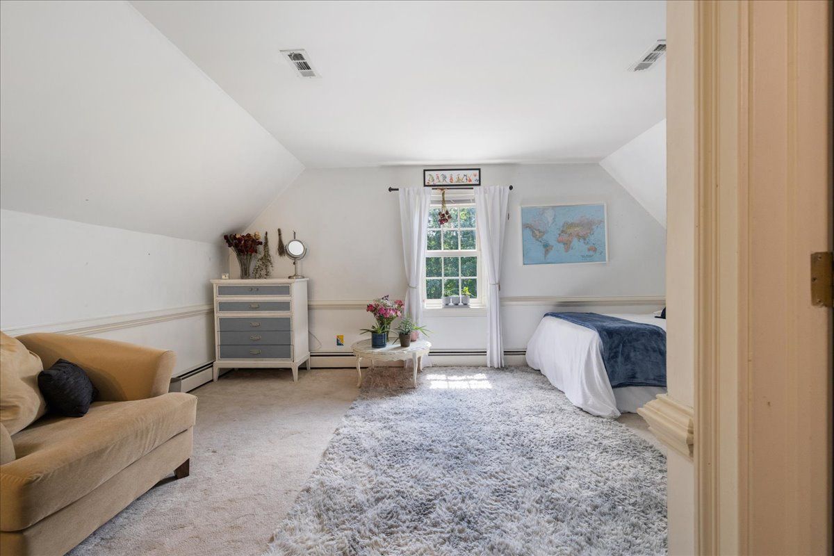 a spacious bedroom with a bed and a desk