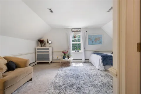 a spacious bedroom with a bed and a desk