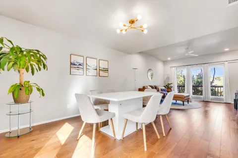 a view of a dining room with furniture and wooden floor