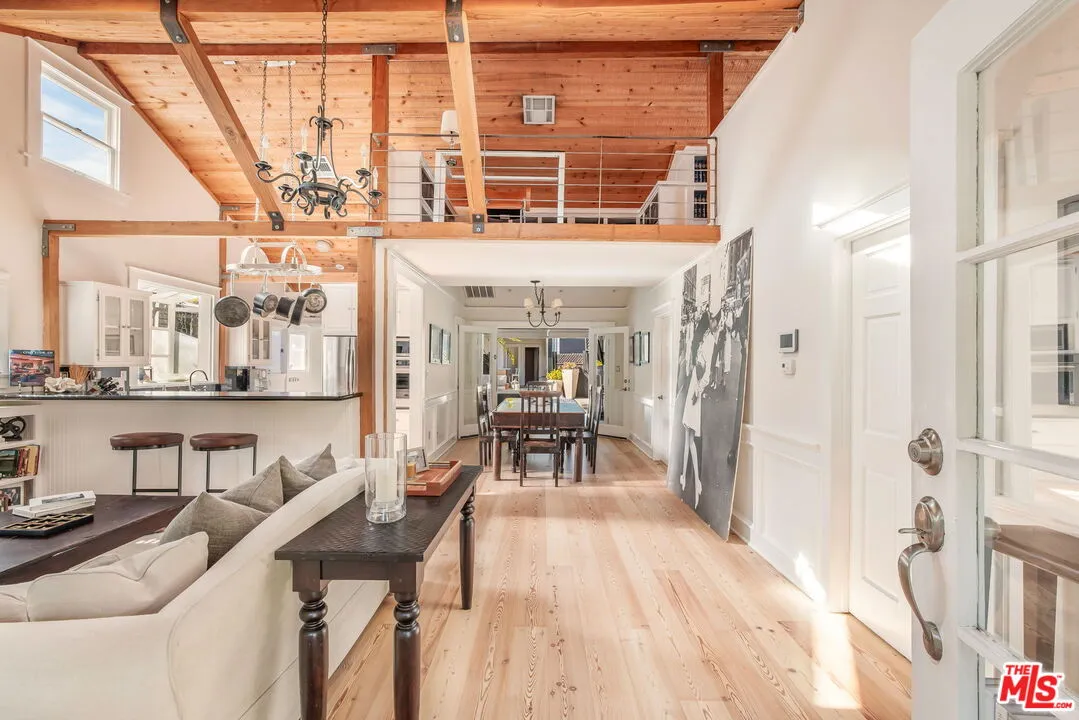 a dining room with furniture and a floor to ceiling window