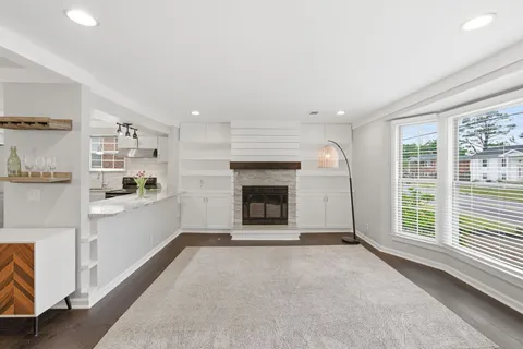 a view of a livingroom with an empty space and a fireplace