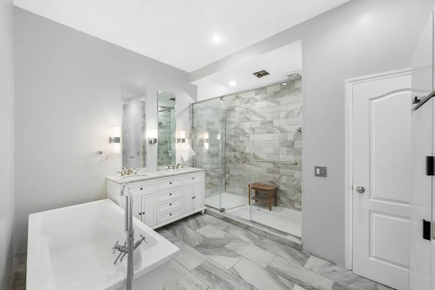 a bathroom with a double vanity sink toilet and shower