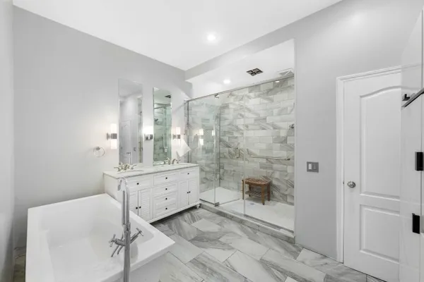 a bathroom with a double vanity sink toilet and shower