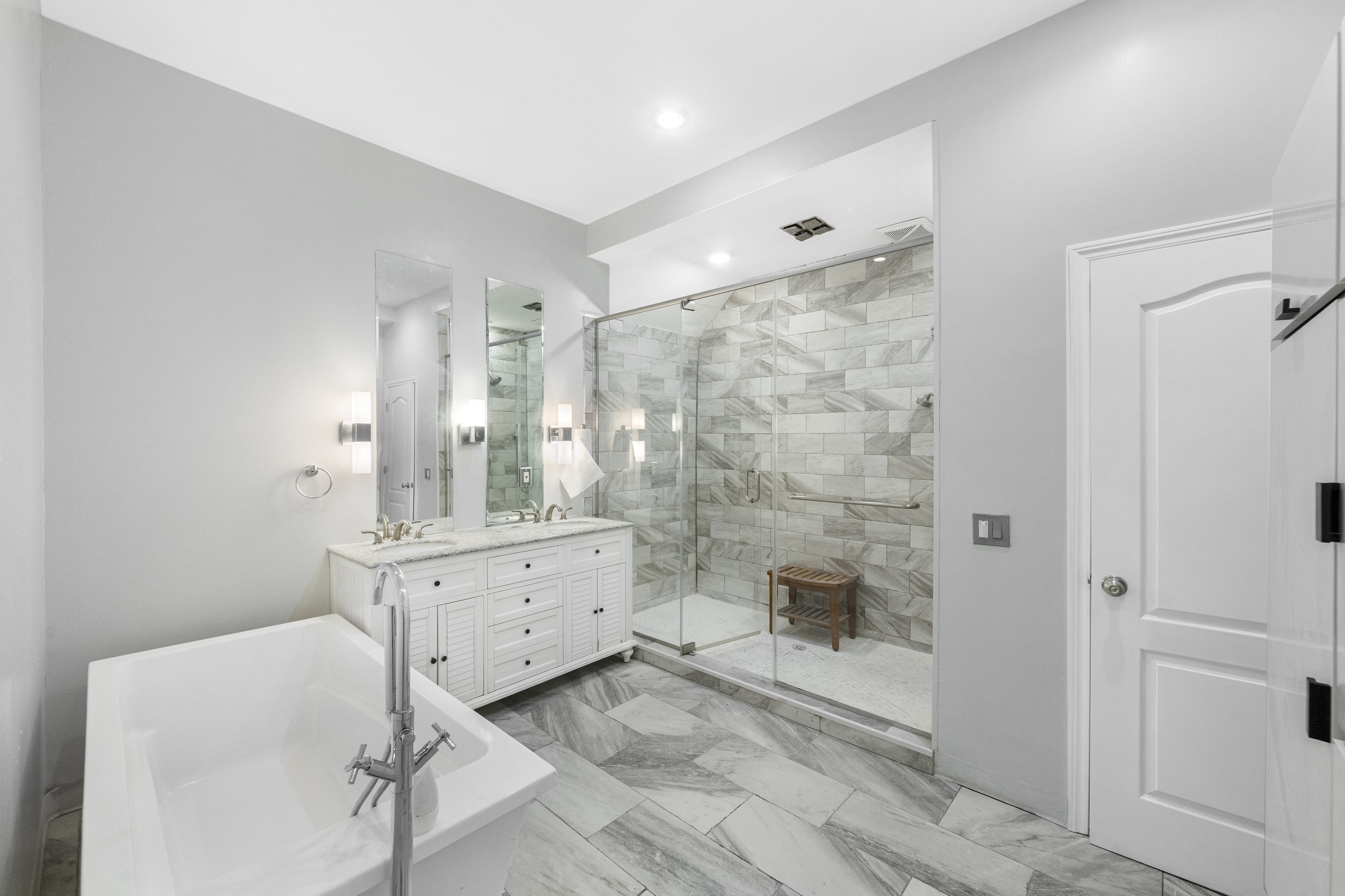 1061 Fulton Street, Unit 1 Brooklyn, NY 11238 - Photo 7 of 13 a bathroom with a double vanity sink toilet and shower