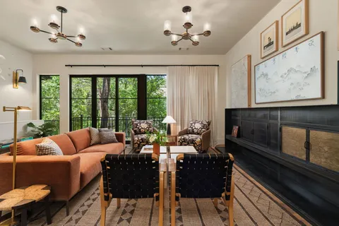 a view of a dining room with furniture and a chandelier