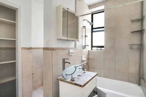 a bathroom with a sink a bath tub and a shower