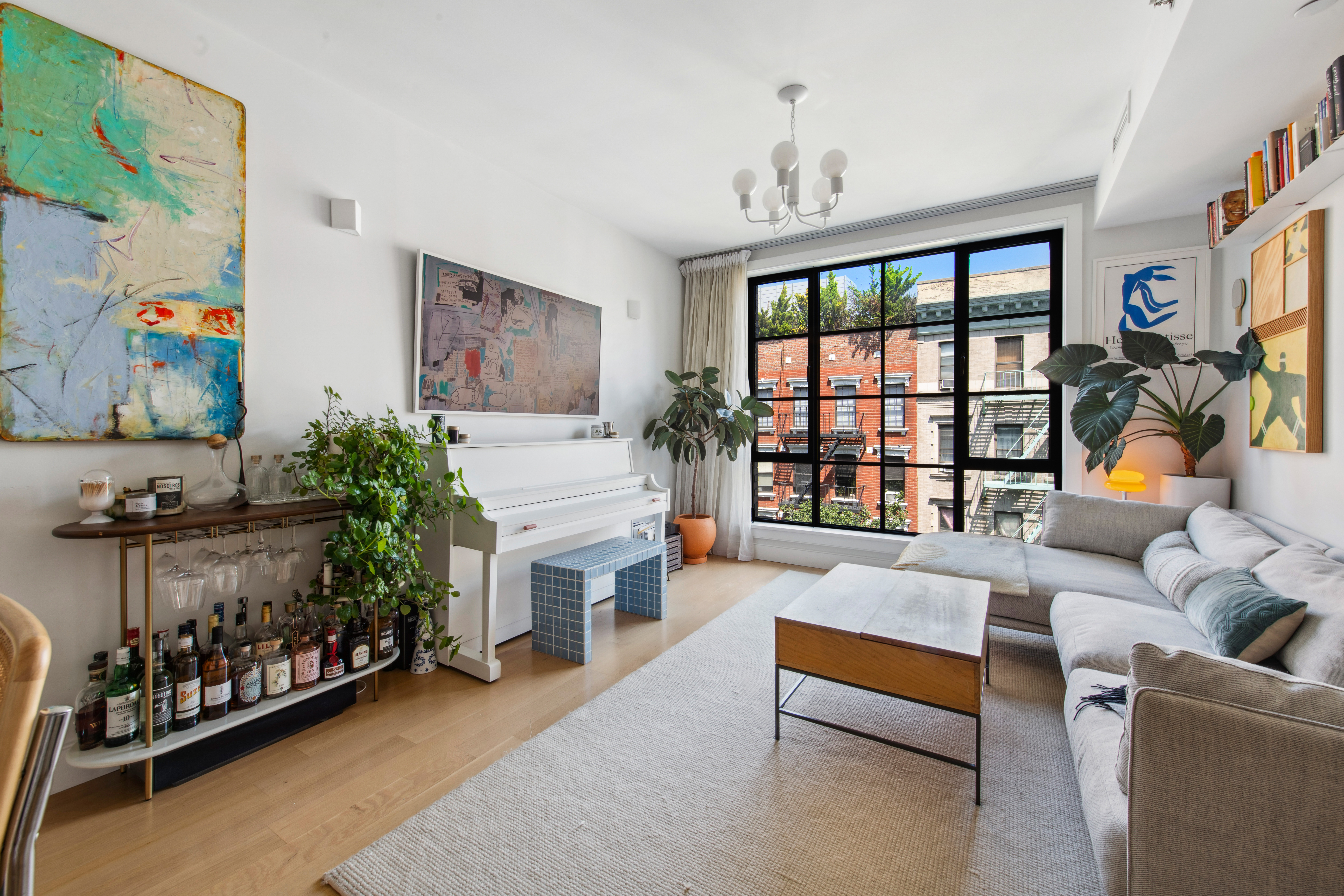 536 East 13th Street, Unit 5F Manhattan, NY 10009 - Photo 2 of 16 a living room with furniture and a large window