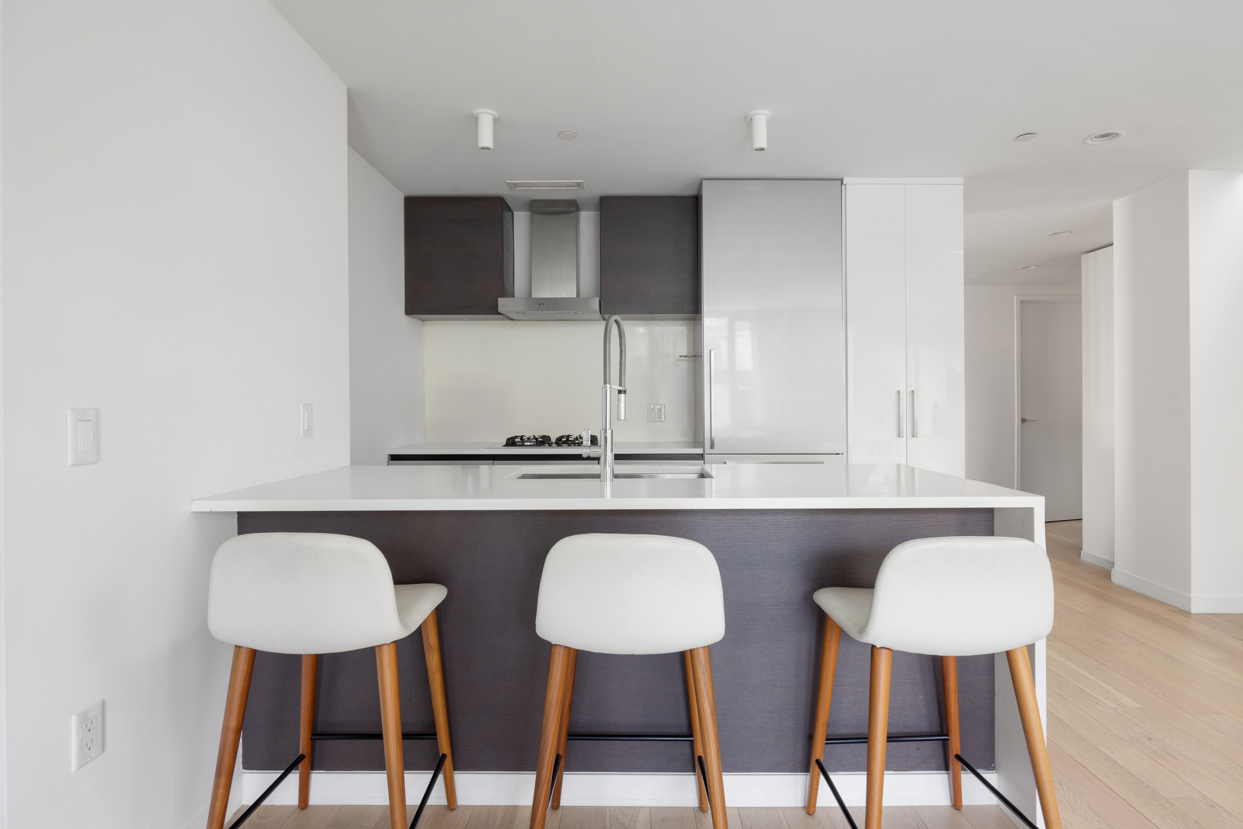 540 West 49th Street, Unit PH1N Manhattan, NY 10019 - Photo 5 of 18 a kitchen with stainless steel appliances a sink and a chair