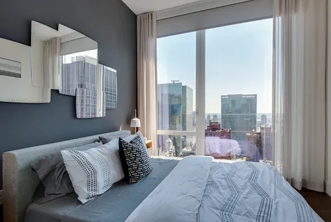 a bedroom with a large bed and a large window