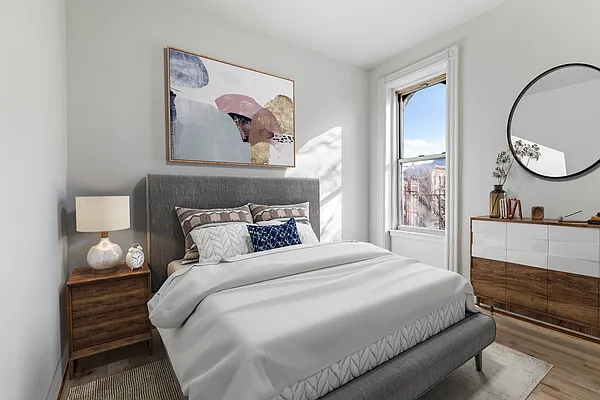 208 Lewis Avenue, Unit 4 Brooklyn, NY 11221 - Photo 3 of 7 a bedroom with a bed and a large mirror on the dresser