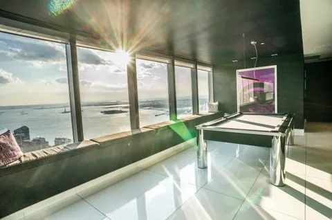 a view of a living room and floor to ceiling window