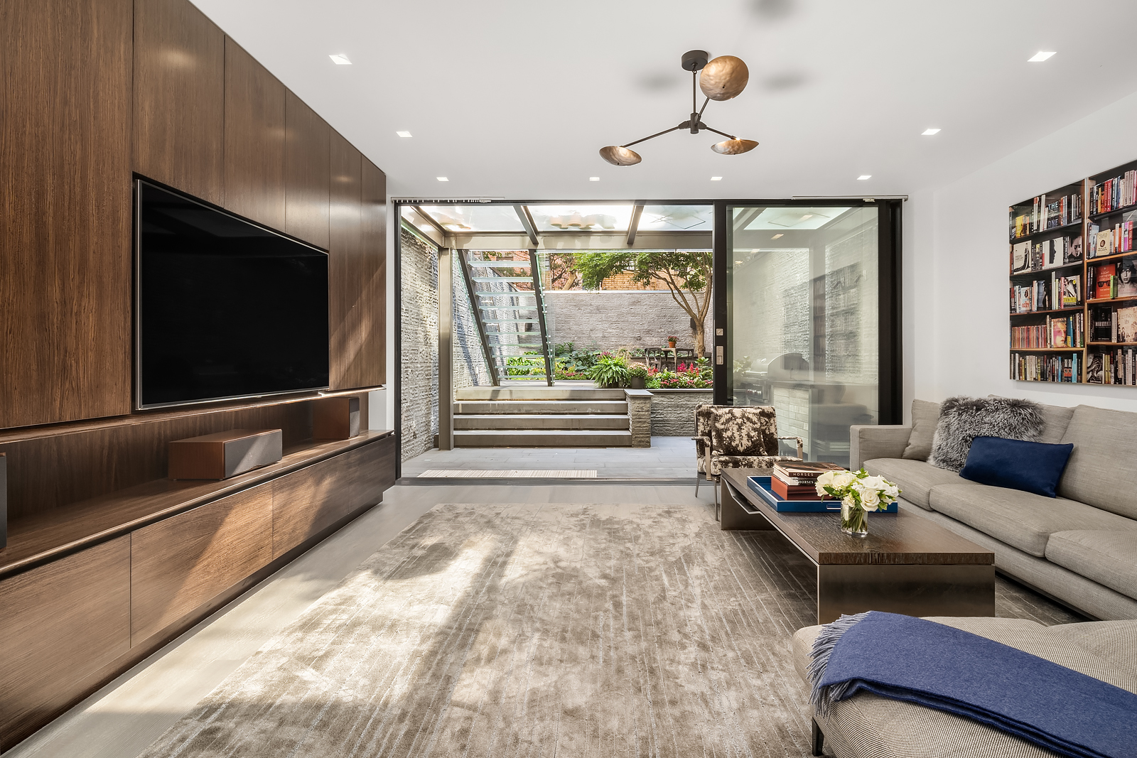 184 East 75th Street Manhattan, NY 10021 - Photo 7 of 20 a living room with furniture and a flat screen tv