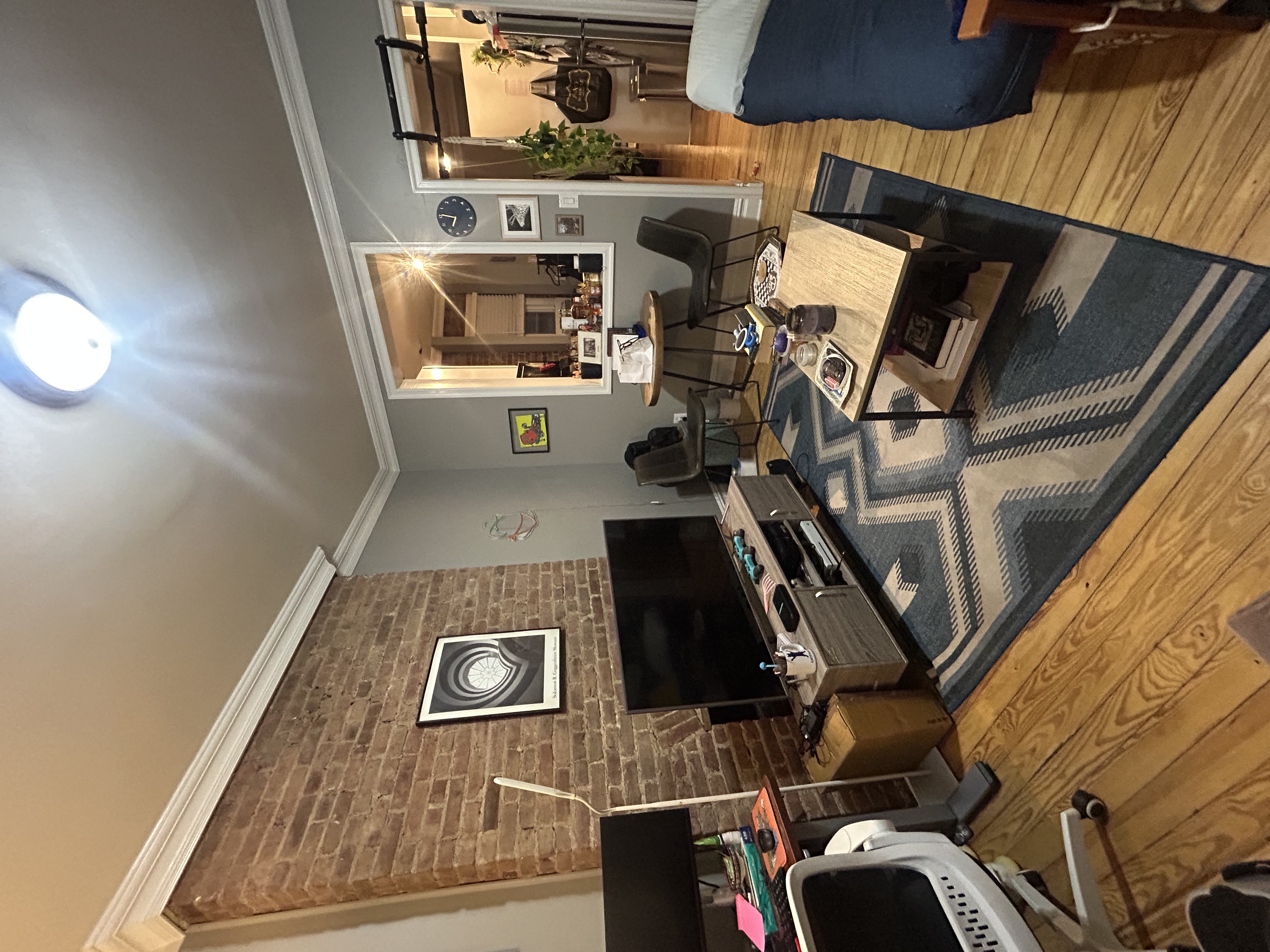 317 East 73rd Street, Unit 1RE Manhattan, NY 10021 - Photo 8 of 9 a work room with furniture a flat screen tv and a fireplace