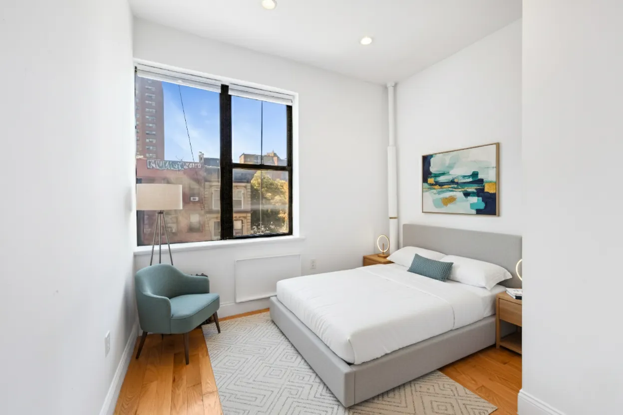 a bedroom with a bed and window