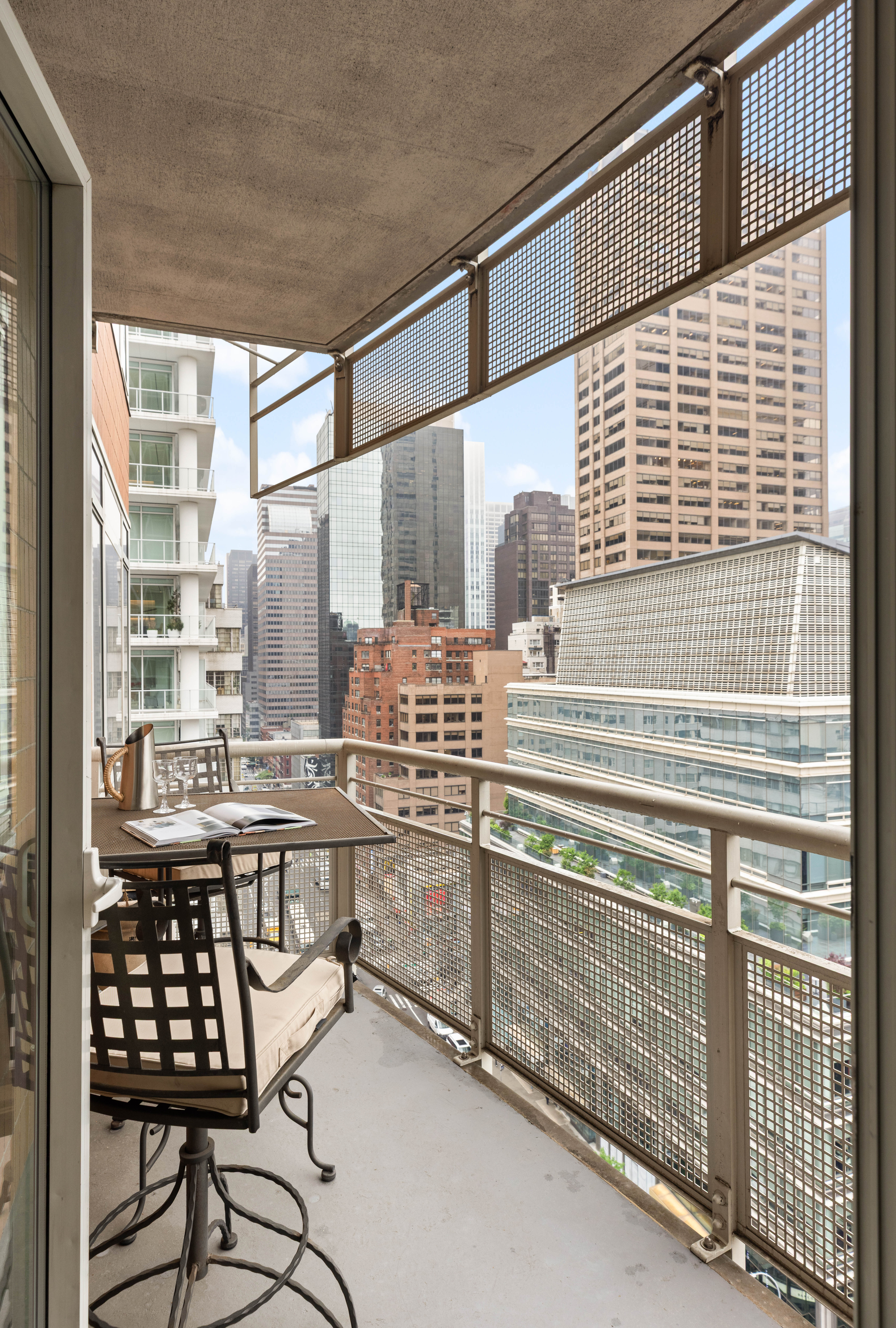 205 East 59th Street, Unit 14B Manhattan, NY 10022 - Photo 4 of 19 a view of a kitchen with a table and chairs