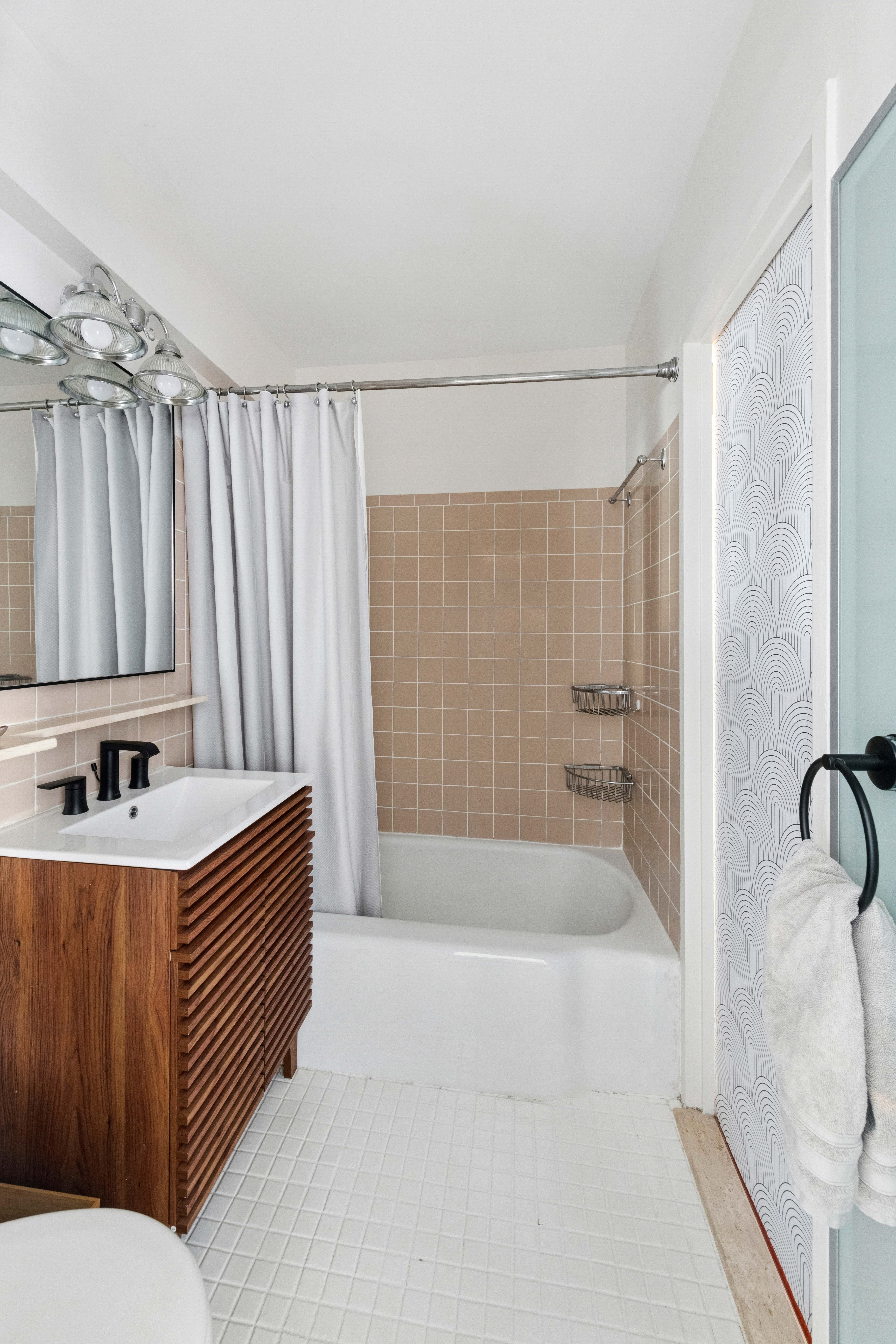 363 East 76th Street, Unit 11K Manhattan, NY 10021 - Photo 9 of 16 a bathroom with a sink a toilet and shower