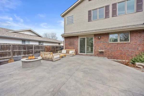 a view of a house with backyard and sitting area