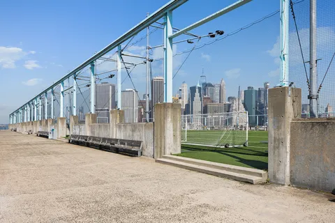 a view of a lake with boats and trees in the background