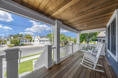 a view of a porch with wooden floor