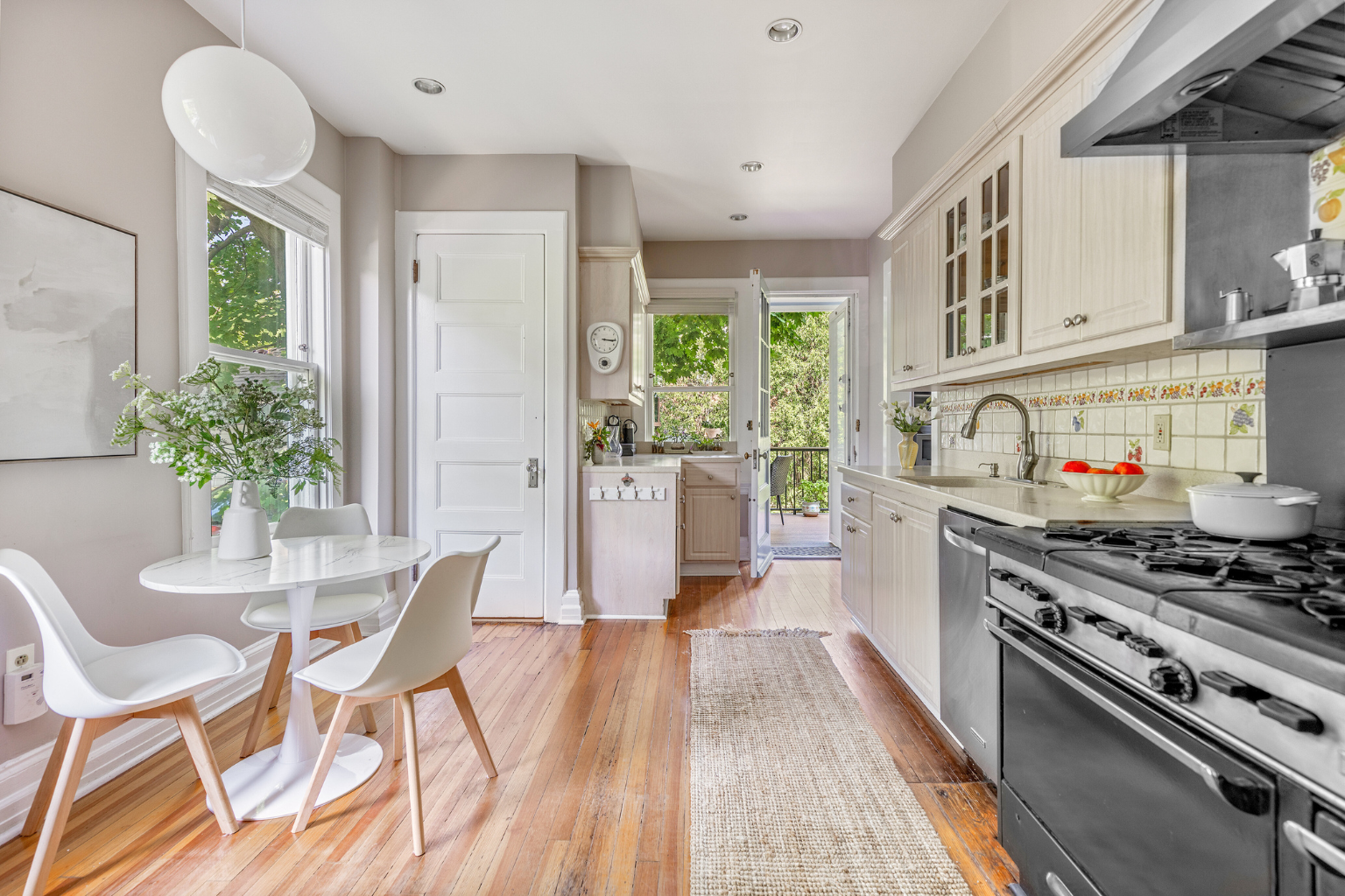 215 Marlborough Road Brooklyn, NY 11226 - Photo 5 of 21 a kitchen with stainless steel appliances a dining table chairs stove and cabinets